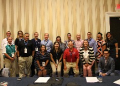 Fulfilling duties at the 2018 CoSIDA Convention community service project: Chris Mitchell and members of the Goodwill and Wellness Committee put together peanut butter and jelly sandwiches as well as bags of trail mix before delivering the items to the local Martha’s Table shelter in National Harbor, Md.